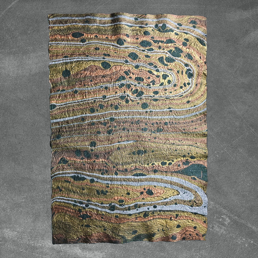 Artisanal green marbled mulberry paper by Kozo Studio, featuring a soft, crinkled texture and one-of-a-kind handmade paper patterns ideal for crafts or decor.