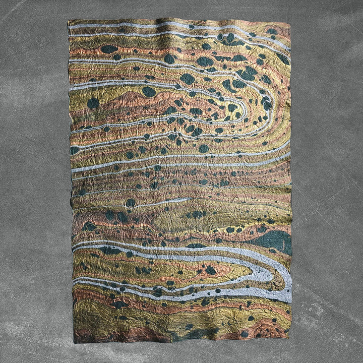 Artisanal green marbled mulberry paper by Kozo Studio, featuring a soft, crinkled texture and one-of-a-kind handmade paper patterns ideal for crafts or decor.