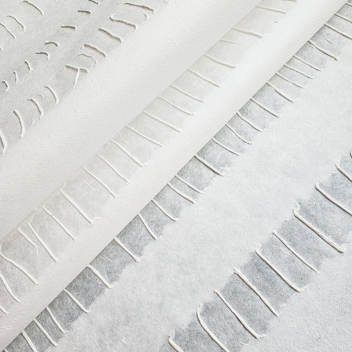 Textured sheet of white handmade mulberry paper by Kozo Studio, highlighting the intricate pulp rubbing technique and artistic stripe pattern.