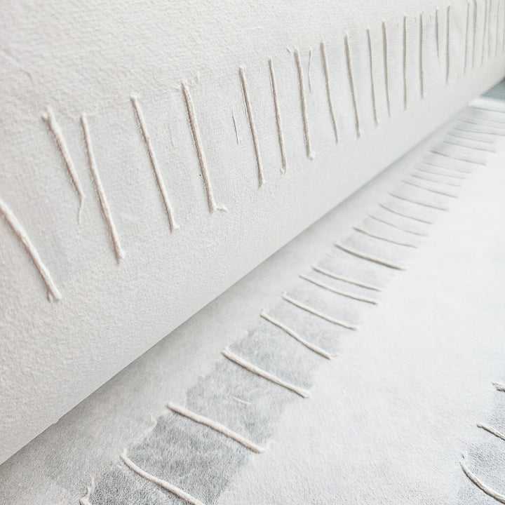 Artistic mulberry paper from Kozo Studio with a sophisticated blend of raised pulp lines and smooth white handmade paper stripes.