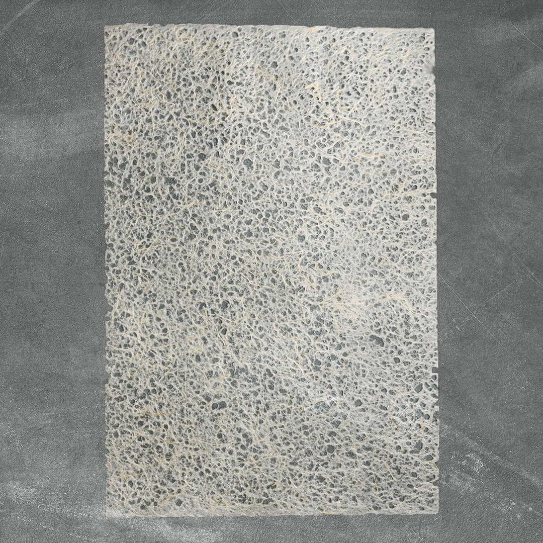 Handmade paper by Kozo Studio featuring Asarakusui technique with water-formed holes, showcasing fibrous layers of mulberry and abaca pulp.