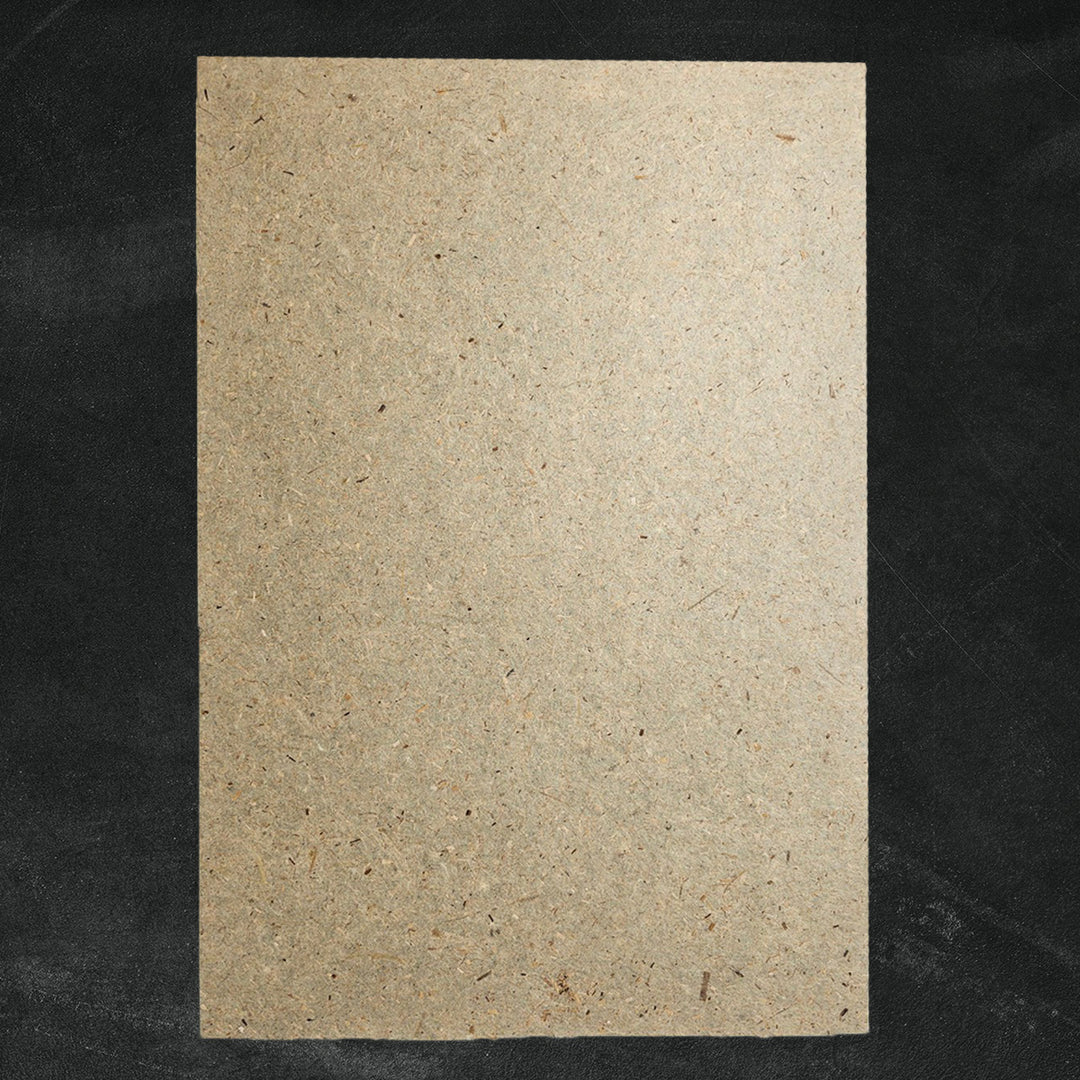 A sheet of textured Banana Paper by Kozo Studio on a dark background features a rustic beige surface with visible specks and fibers, offering a natural look.