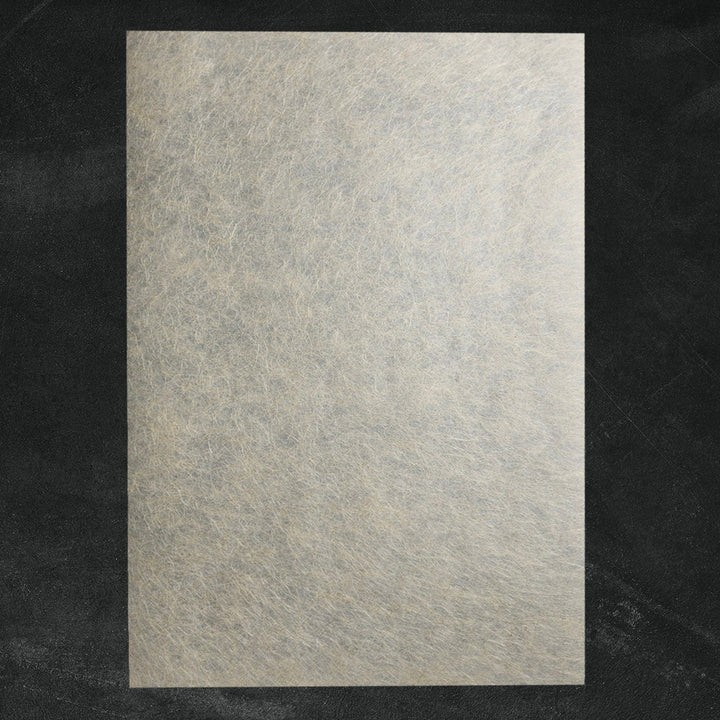 Golden-toned mulberry paper crafted at Kozo Studio with a blend of Kozo and Manila Hemp fibers, perfect for elegant handmade paper projects like gift wrapping and art prints.