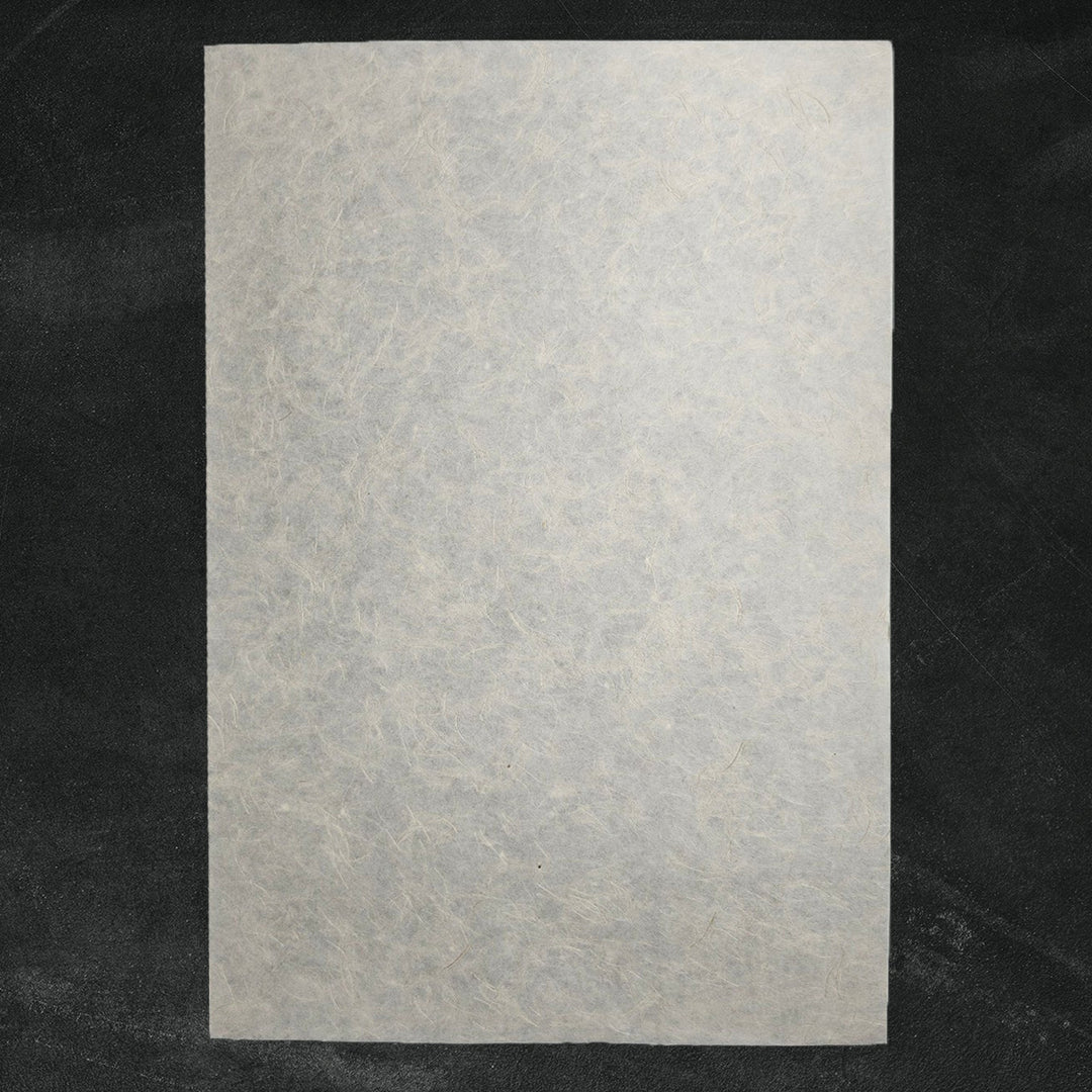 Detailed view of Mikado Kozo mulberry paper crafted by Kozo Studio, featuring natural hemp strands and a flexible, elegant handmade paper texture.