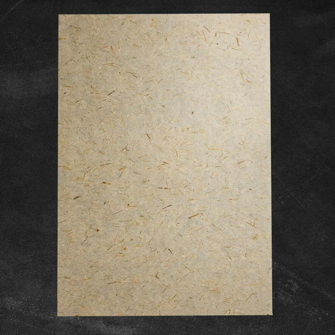 Natural mulberry paper by Kozo Studio, showcasing visible straw fibers in a lightweight handmade paper ideal for decorative projects.