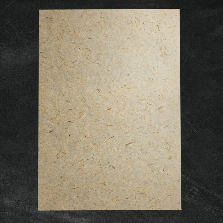 Natural mulberry paper by Kozo Studio, showcasing visible straw fibers in a lightweight handmade paper ideal for decorative projects.