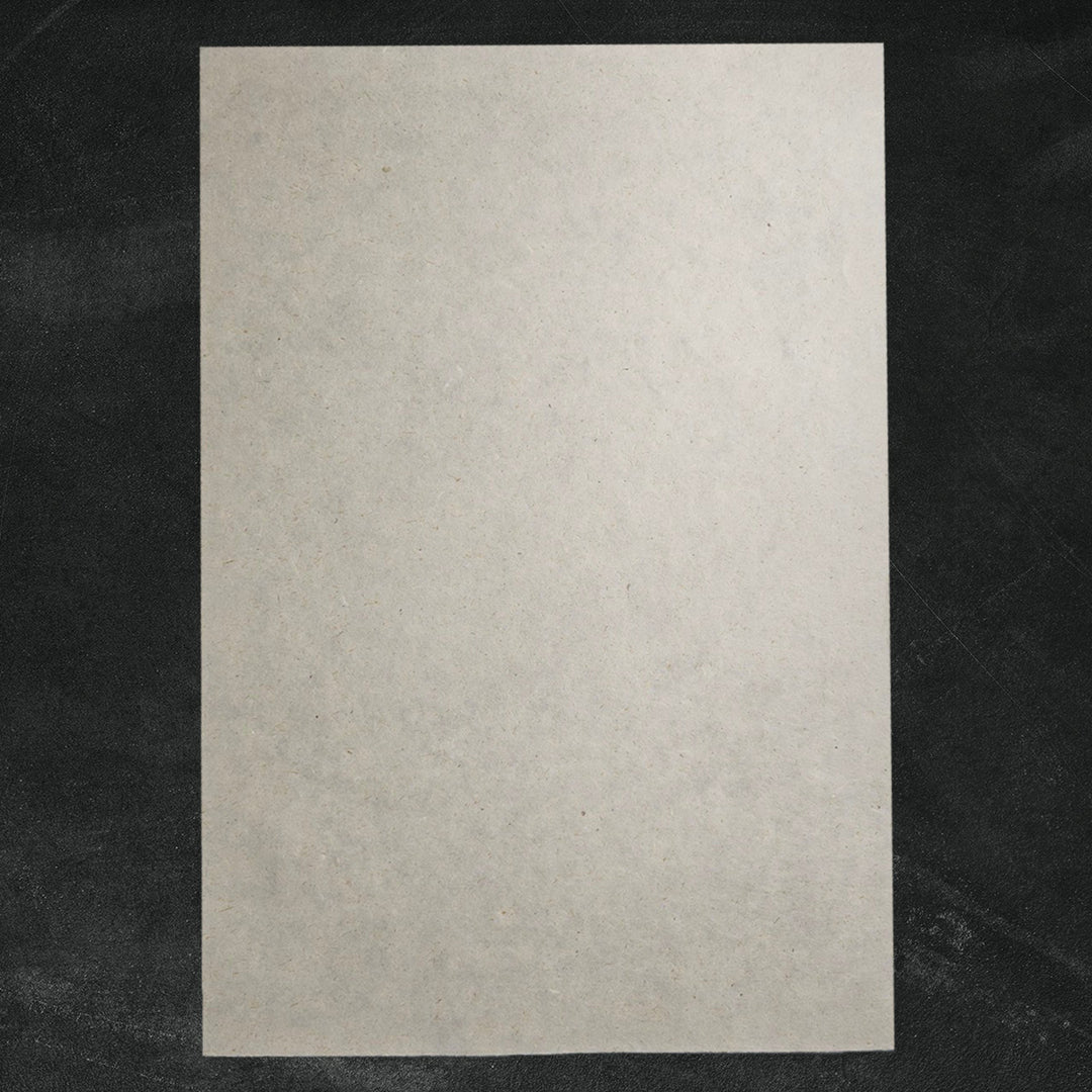 Textured handmade paper made with sugarcane and kozo pulp from Kozo Studio, featuring a lightly fibrous, artisanal finish perfect for crafts.