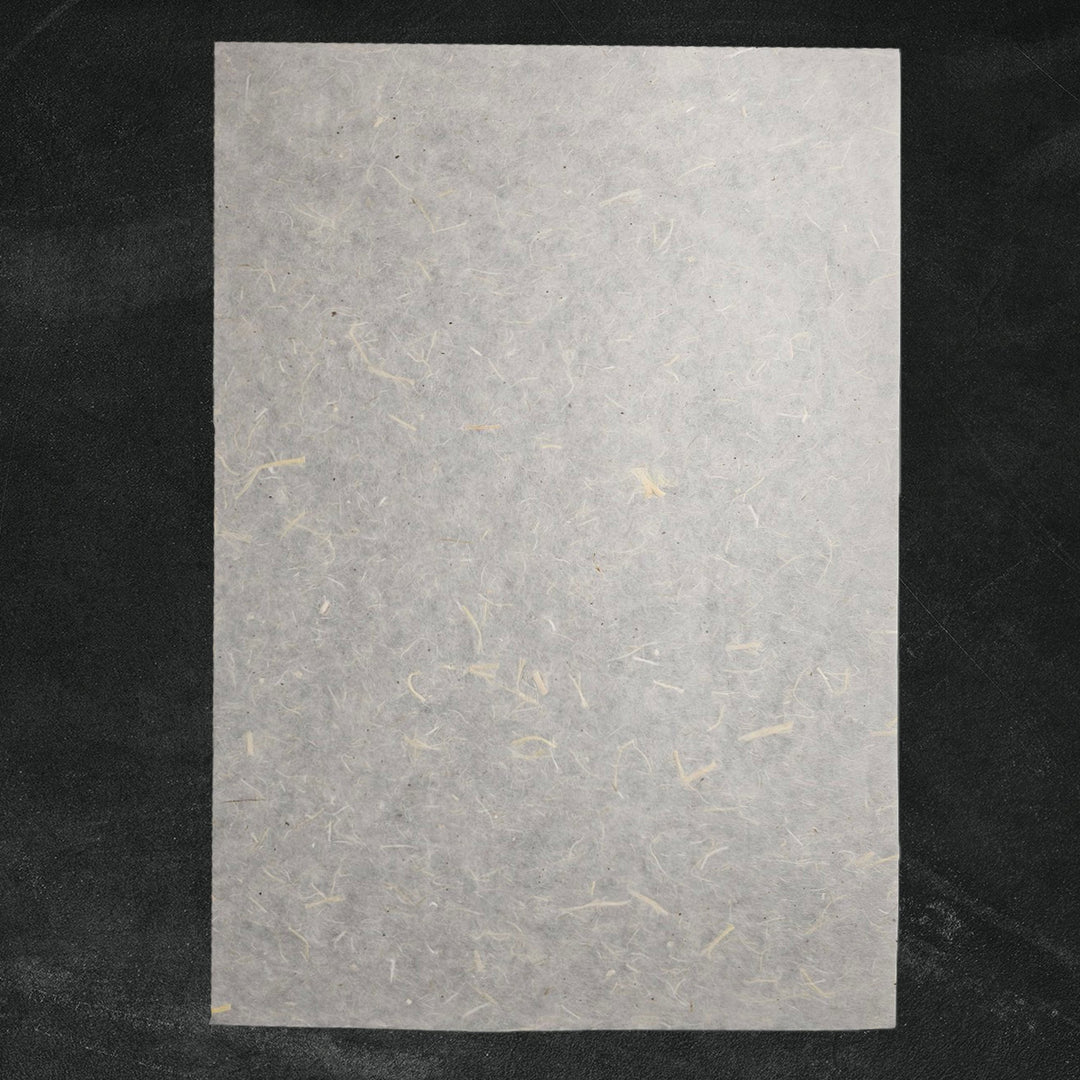 Handmade Unryu paper by Kozo Studio showcasing natural mulberry bark inclusions and rough fiber texture, perfect for art and craft projects.