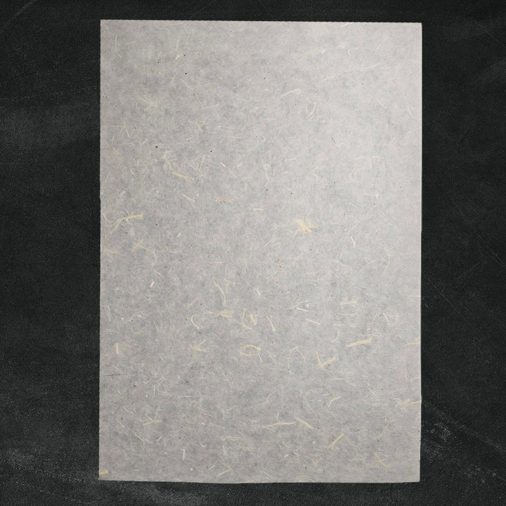 Handmade Unryu paper by Kozo Studio showcasing natural mulberry bark inclusions and rough fiber texture, perfect for art and craft projects.