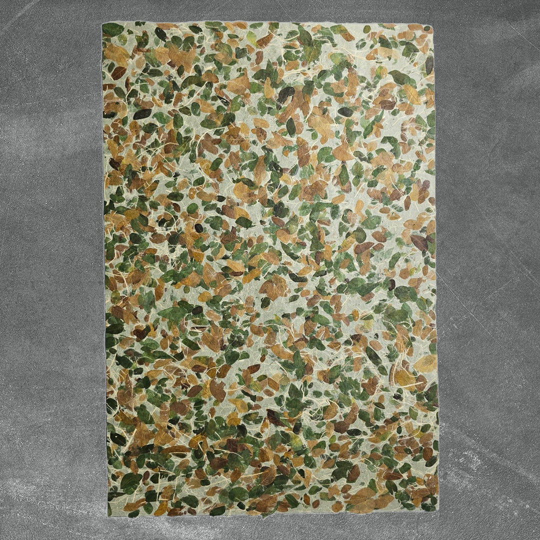 Decorative mulberry paper crafted at Kozo Studio, showcasing embedded Raintree leaves and strong handmade kozo fibers, ideal for nature-inspired crafts.