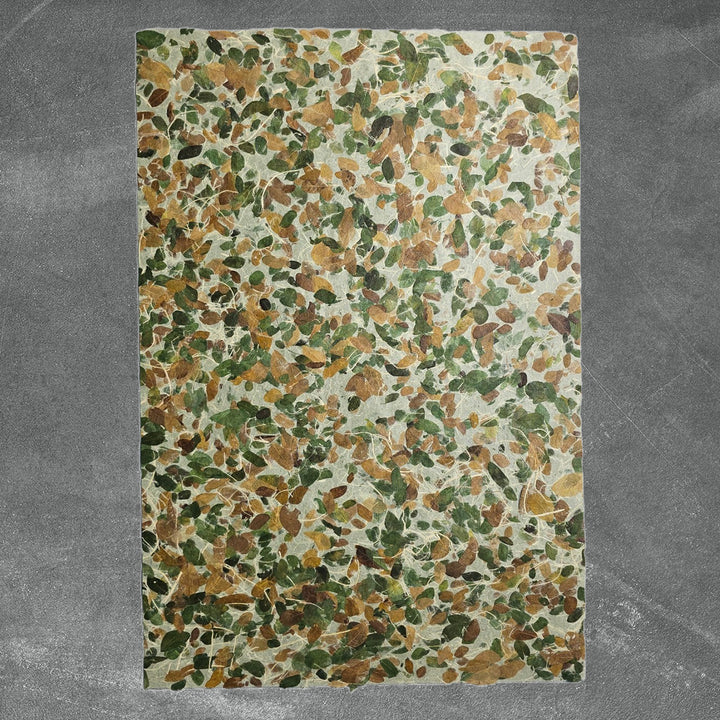 Decorative mulberry paper crafted at Kozo Studio, showcasing embedded Raintree leaves and strong handmade kozo fibers, ideal for nature-inspired crafts.