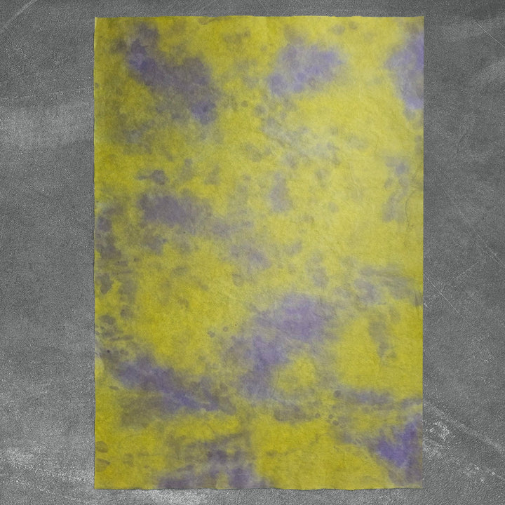 Hand-colored handmade paper by Kozo Studio, featuring the Canary Glow Ombre Mulberry Paper with a seamless yellow to bluish-purple transition and soft textured surface.