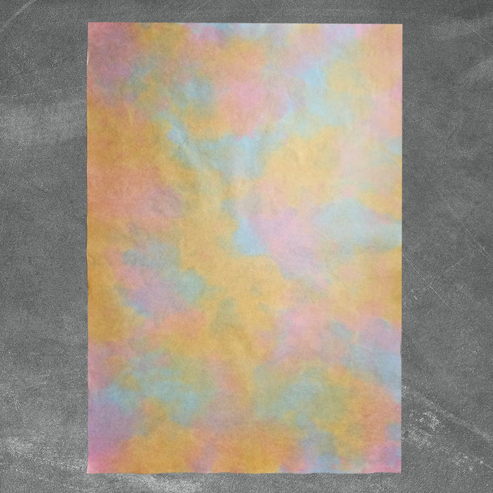 Textured handmade paper by Kozo Studio shown in an artistic ombre gradient of yellow and pink shades, crafted from high-quality mulberry paper with a soft, luxurious surface.