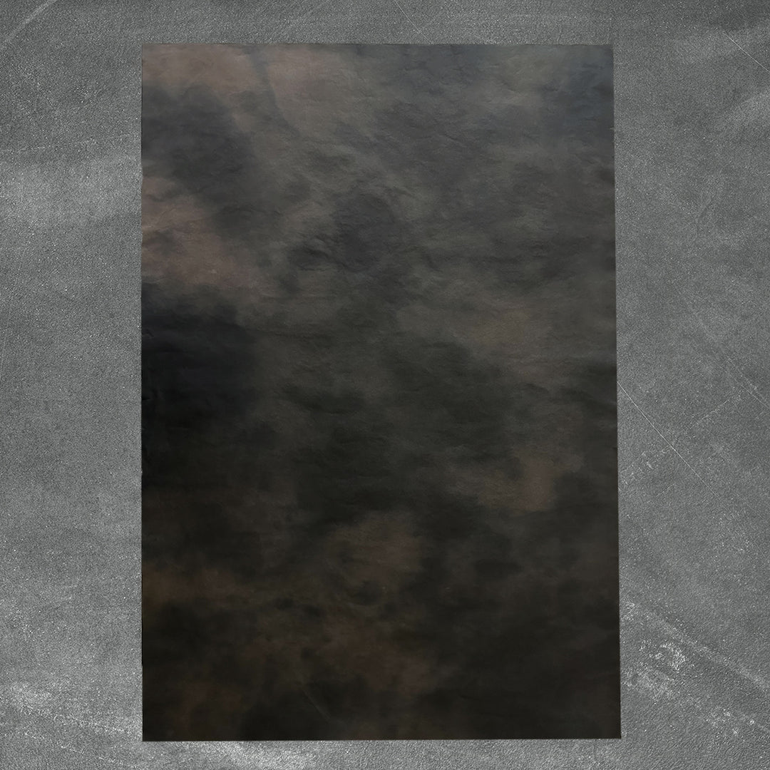 A gradient blend of dark tones in Kozo Studio's Ombre handmade paper made from mulberry pulp, highlighting the unique smoky effect and natural texture of artisanal paper.