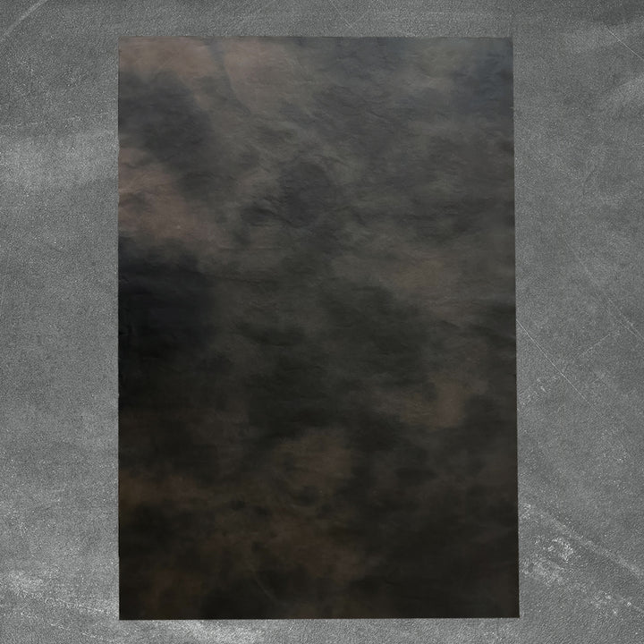 A gradient blend of dark tones in Kozo Studio's Ombre handmade paper made from mulberry pulp, highlighting the unique smoky effect and natural texture of artisanal paper.