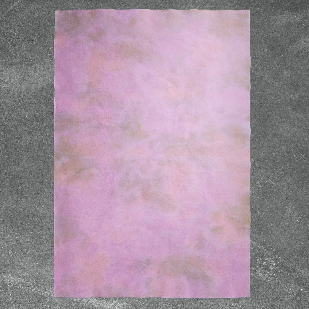 Ombre Kozo Paper in Pink Haze by Kozo Studio showcases handmade paper with soft pink and brown gradients, crafted from delicate mulberry paper with a naturally textured surface.