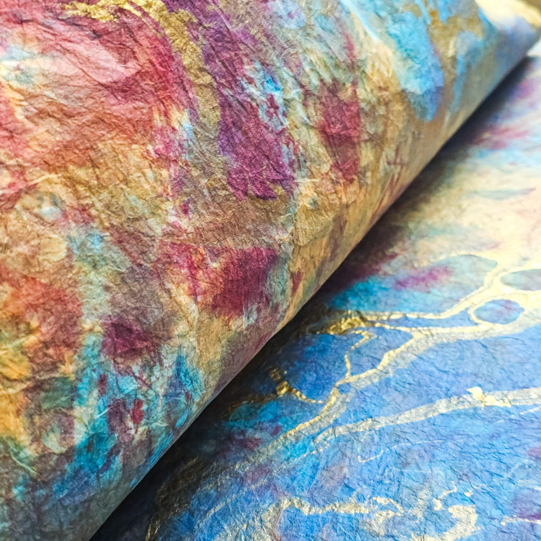 High-resolution view of handmade paper from Kozo Studio, with vivid marbled swirls on softly layered mulberry paper, emphasizing artisanal detail.