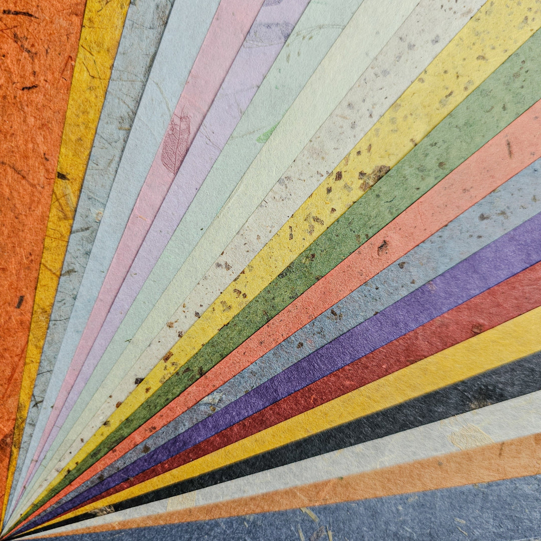 The Kozo Studio Assorted A4 Mix Leaf & Flower Mulberry Paper Set (40 Sheets) features colorful, fiber-rich sheets in orange, blue, purple, green, yellow, and gray—ideal for DIY crafts and creative projects.
