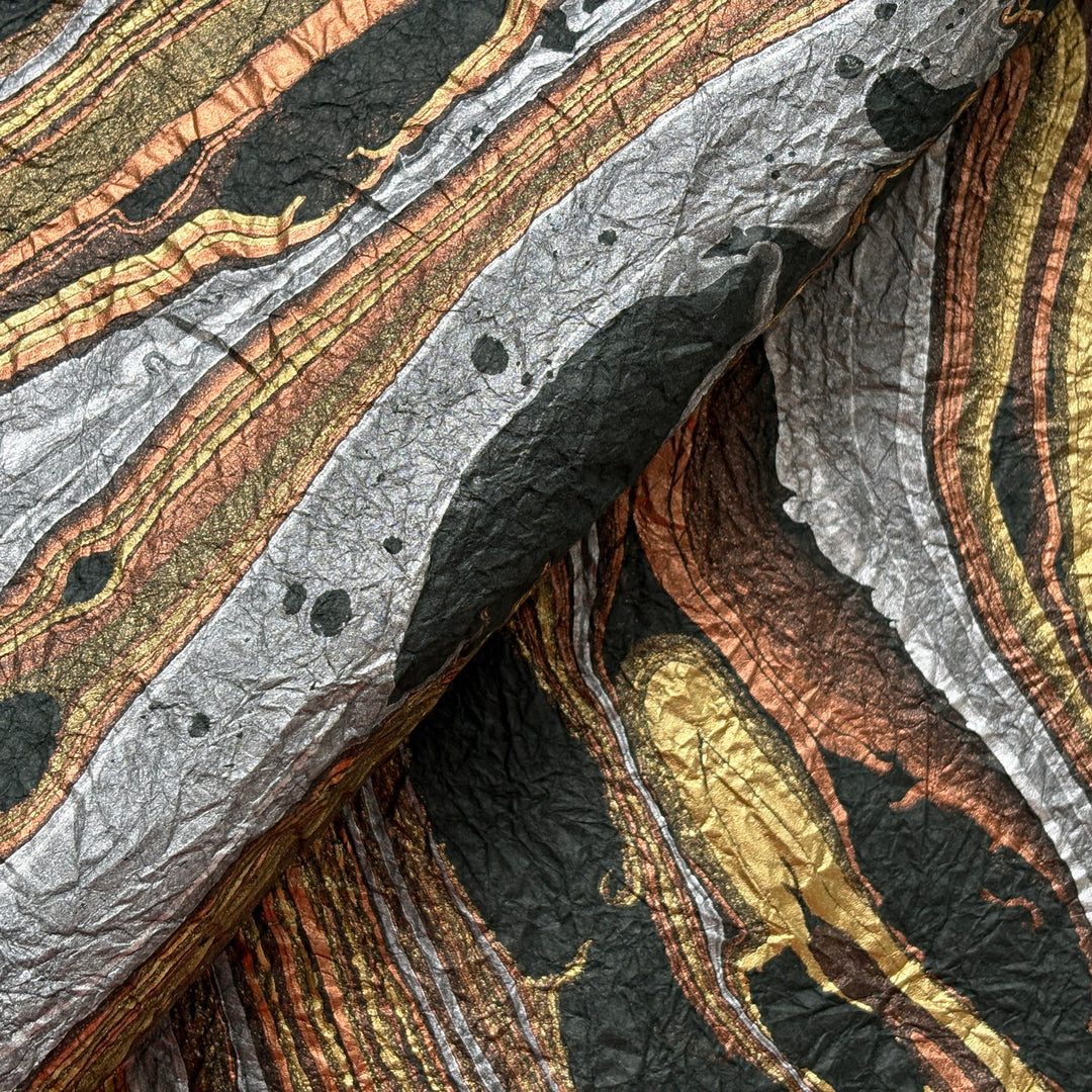 Milano Kozo Paper – Design 9 (Green) embodies artisanal beauty with its graceful marbled design. Handmade by delicately layering mulberry paper over swirling oil-based colors, each sheet boasts a distinct, one-of-a-kind pattern and a soft, fabric-like crinkled texture. Its sophisticated look and exceptional quality make it ideal for creative projects, detailed crafts, or as a striking decorative statement on its own.