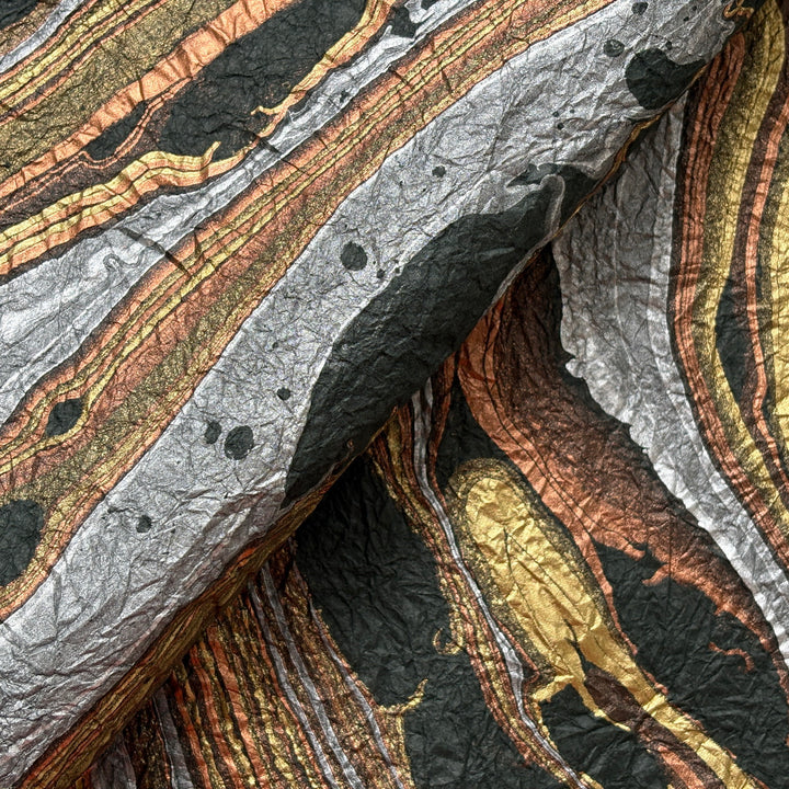 Milano Kozo Paper – Design 9 (Green) embodies artisanal beauty with its graceful marbled design. Handmade by delicately layering mulberry paper over swirling oil-based colors, each sheet boasts a distinct, one-of-a-kind pattern and a soft, fabric-like crinkled texture. Its sophisticated look and exceptional quality make it ideal for creative projects, detailed crafts, or as a striking decorative statement on its own.