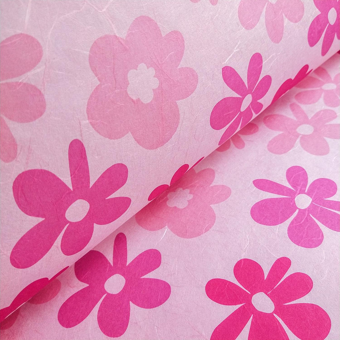 Handmade mulberry paper by Kozo Studio with vivid Caribbean floral patterns in fuchsia and pink, showcasing bold petals and playful design.