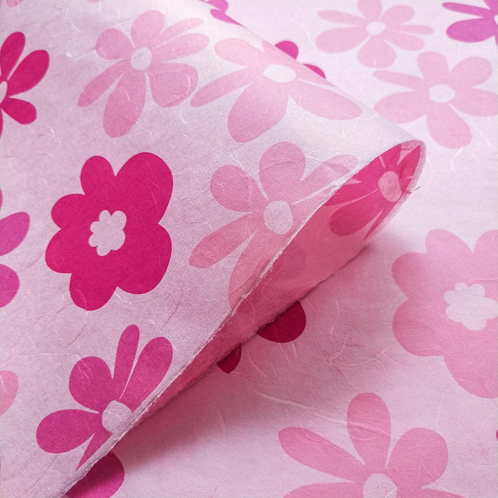 Vibrant close-up of Kozo Studio screen-printed mulberry paper with tropical pink flower motifs on high-quality handmade paper.