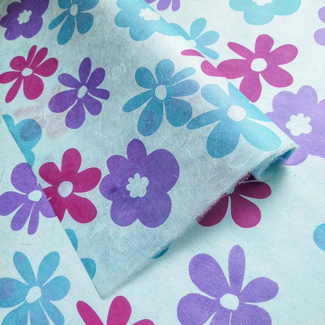 Kozo Studio screen-printed mulberry paper in sky blue, handmade with overlapping floral patterns in bright Caribbean-inspired colors.