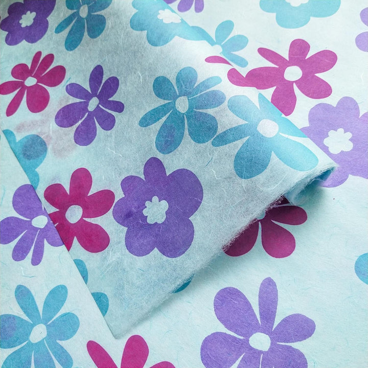 Kozo Studio screen-printed mulberry paper in sky blue, handmade with overlapping floral patterns in bright Caribbean-inspired colors.