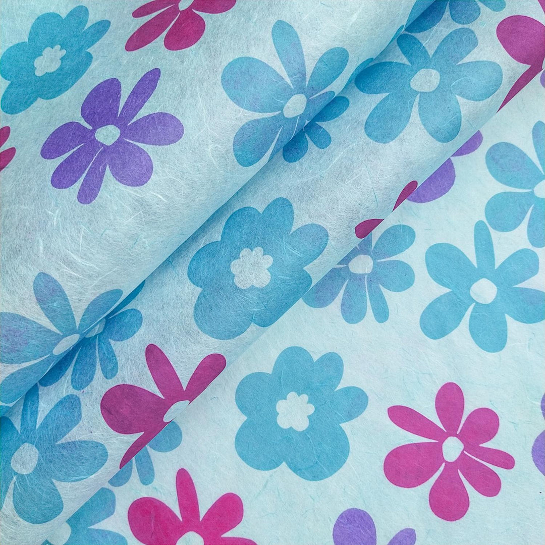 Caribbean-inspired screen-printed mulberry paper in sky blue from Kozo Studio, featuring handmade paper with vibrant pink, purple, and blue floral patterns.