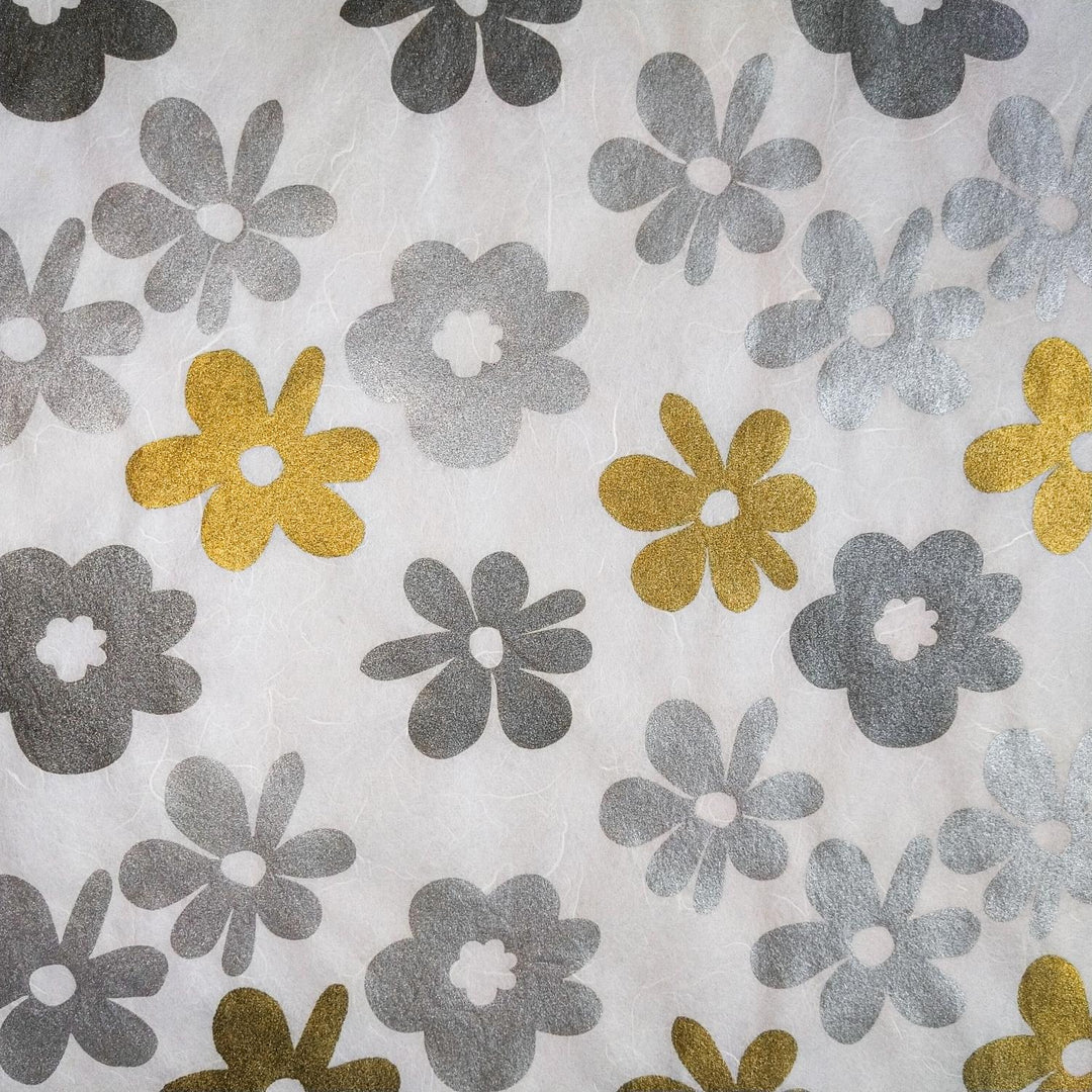 Vibrant handmade mulberry paper from Kozo Studio with screen-printed tropical flowers in silver and gold, perfect for adding flair to creative projects.