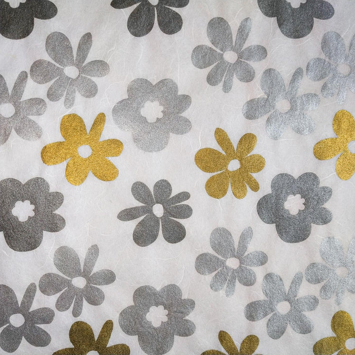 Vibrant handmade mulberry paper from Kozo Studio with screen-printed tropical flowers in silver and gold, perfect for adding flair to creative projects.