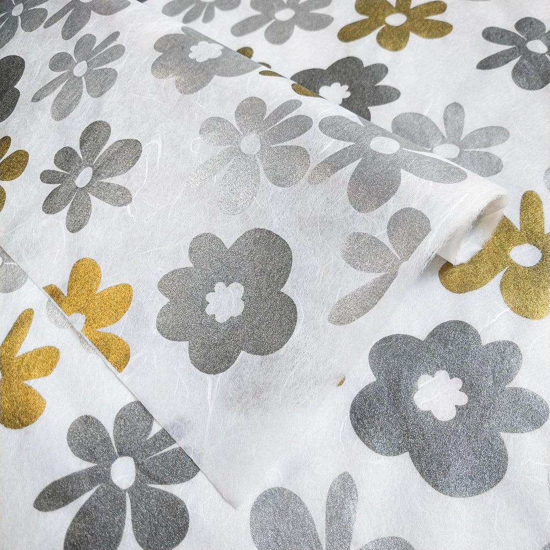 White Caribbean-themed kozo paper by Kozo Studio, showcasing colorful and metallic floral prints on a smooth mulberry paper surface with varied textures.