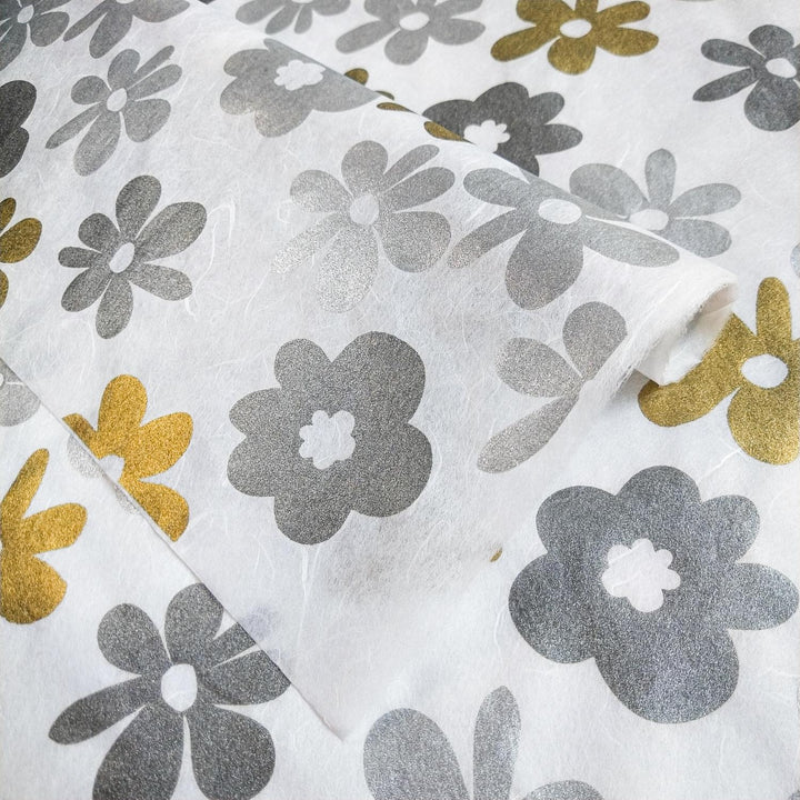 White Caribbean-themed kozo paper by Kozo Studio, showcasing colorful and metallic floral prints on a smooth mulberry paper surface with varied textures.