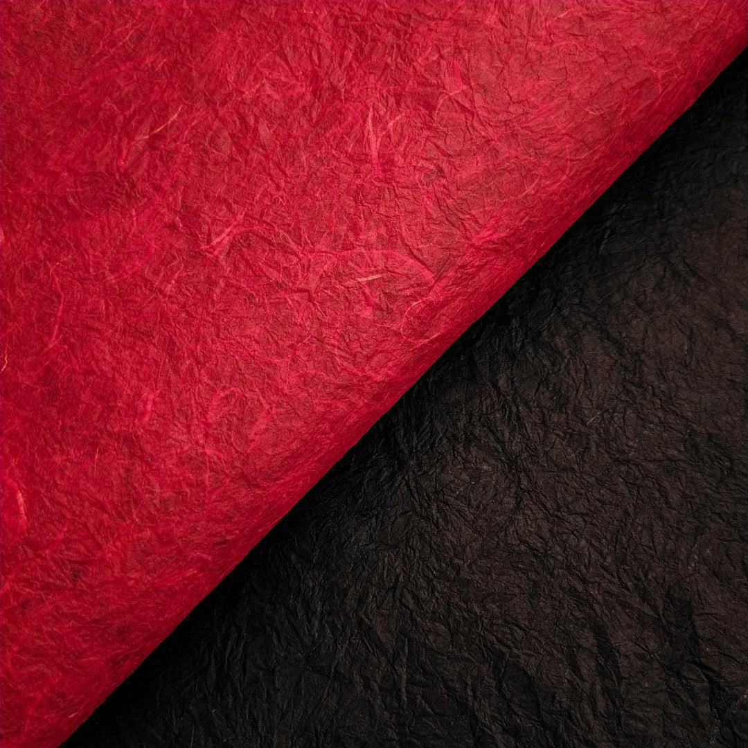 Kozo Studio handmade paper image featuring curled red and black mulberry paper with fibrous, crinkled texture ideal for creative projects.
