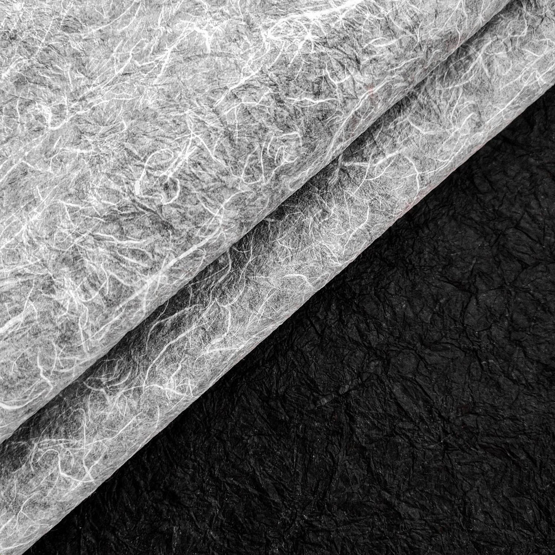 Double-sided handmade mulberry paper from Kozo Studio with crinkled Momigami finish, featuring rough texture and bold color contrast for versatile use in crafts.