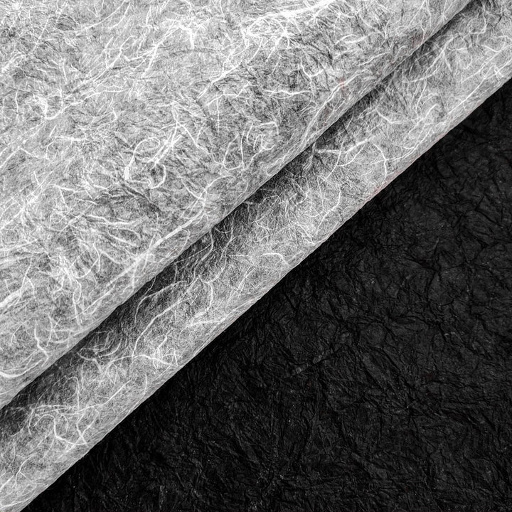 Double-sided handmade mulberry paper from Kozo Studio with crinkled Momigami finish, featuring rough texture and bold color contrast for versatile use in crafts.