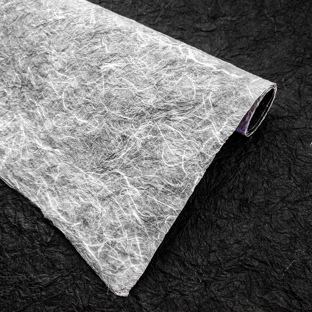 Kozo Studio’s handcrafted Momigami paper in black and white, showcasing the organic texture and contrast of high-quality mulberry paper perfect for creative projects.