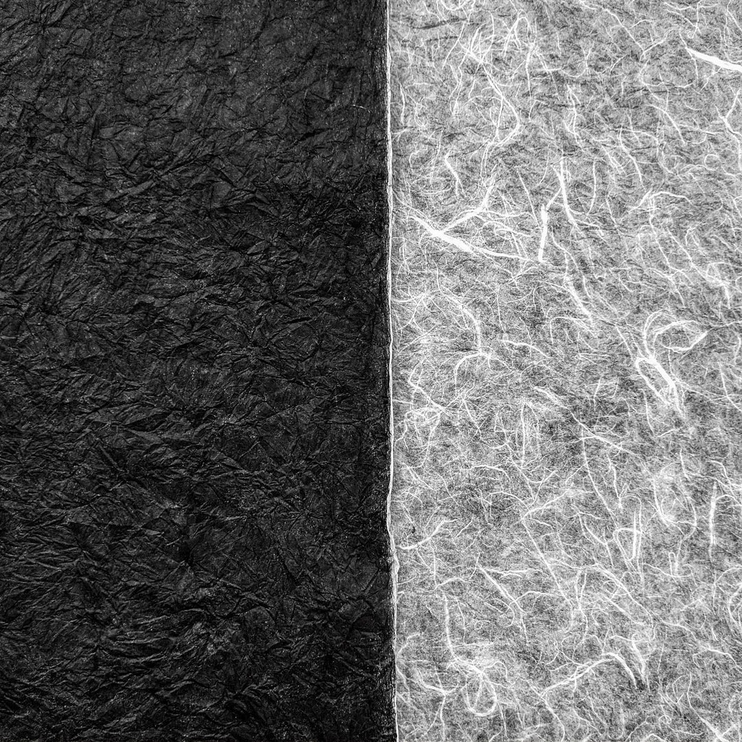 Close-up of Kozo Studio’s double-sided Momigami Kozo paper showing the fibrous, tactile surface of premium handmade mulberry paper in contrasting black and white