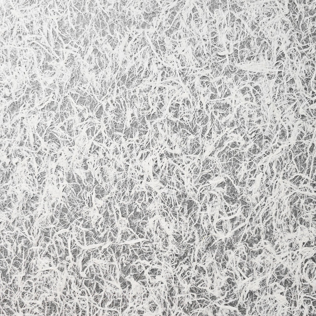 Close-up of strong yet delicate Kozo Studio mulberry paper with visible natural fibers, used in high-end crafts and artistic design projects.
