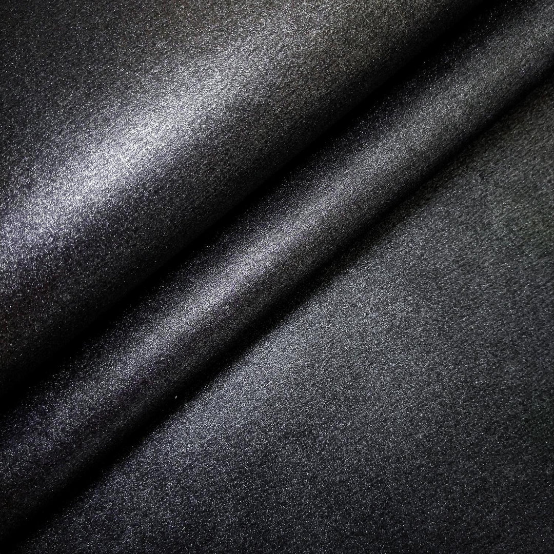 Textured surface of Kozo Studio's handmade mulberry paper in black, featuring a glistening metallic sheen and consistent kozo texture for luxurious creative use.