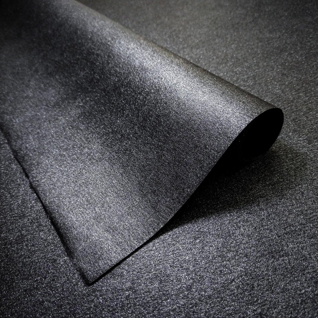 Close-up of Gleaming Metallic Kozo Paper in black by Kozo Studio, a luxurious handmade mulberry paper with a shimmering metallic surface and subtle kozo texture.