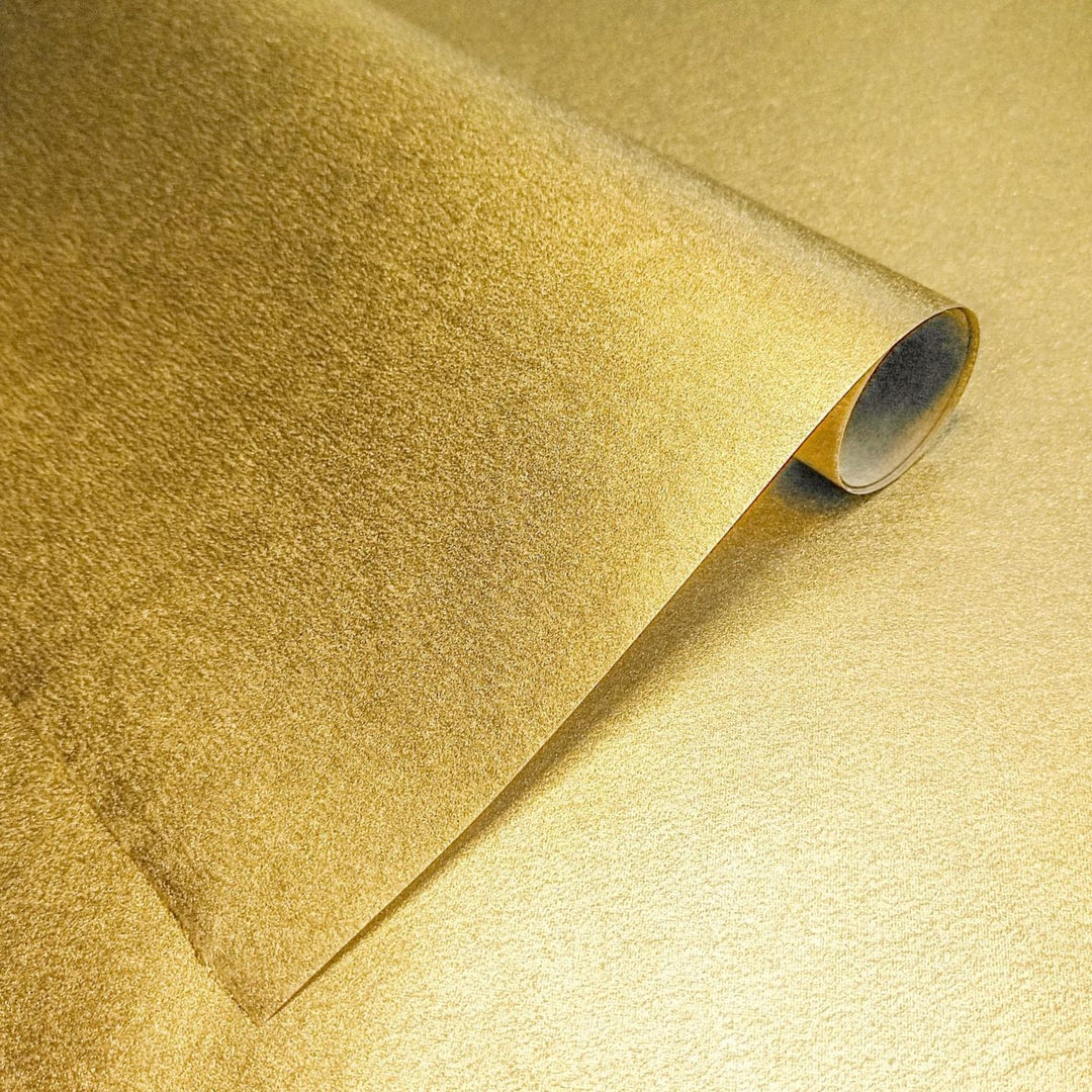 Gleaming metallic handmade paper crafted from kozo fiber, showcasing a golden mulberry paper texture by Kozo Studio.