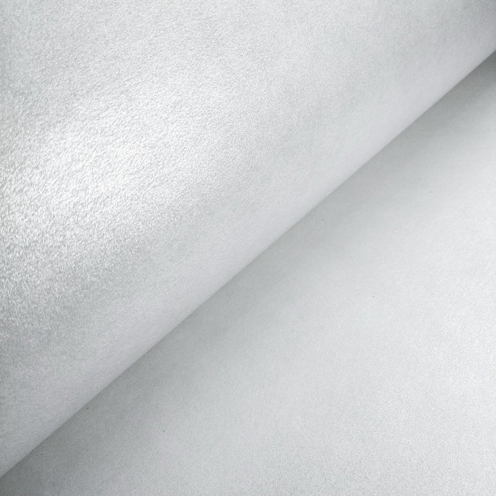 Reflective metallic mulberry paper by Kozo Studio, made from kozo fiber, rolled out to display its fine handmade texture and silver-toned shine.