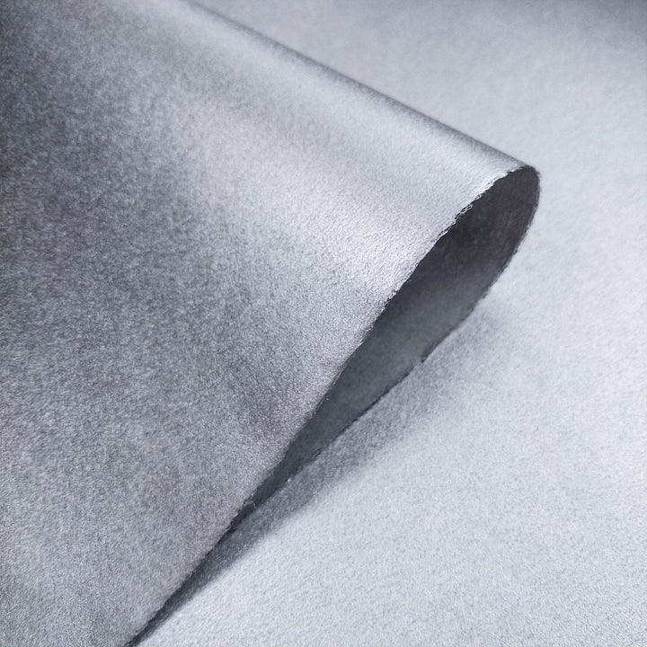 High-resolution image of handmade mulberry paper from Kozo Studio, featuring a shimmering metallic surface and delicate kozo fiber details.