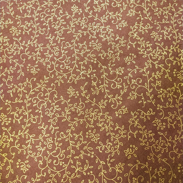 Intricate gold floral pattern with swirling vines on brown Kozo Studio handmade paper, crafted from premium mulberry paper.