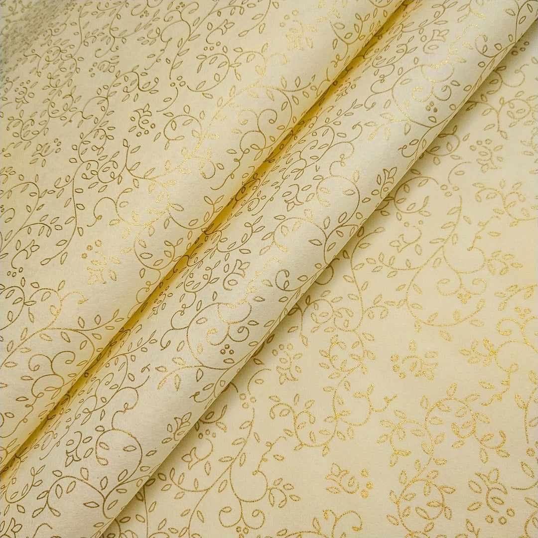 Kozo Studio's Grapevine print handmade paper roll with gold floral accents on smooth ivory mulberry paper, artistically unfurled.