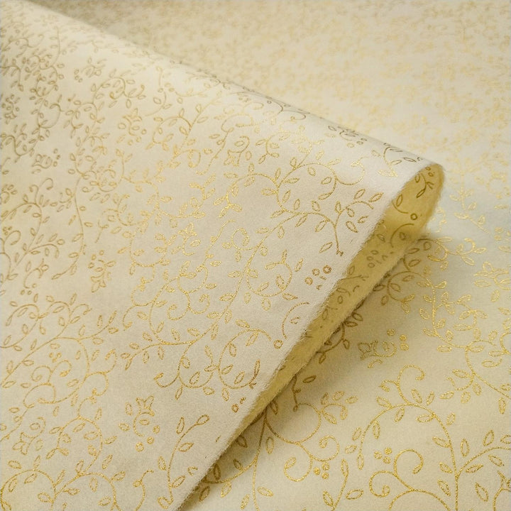 Fine handmade paper by Kozo Studio displaying a gold floral design screen-printed on cream mulberry paper with delicate botanical details.