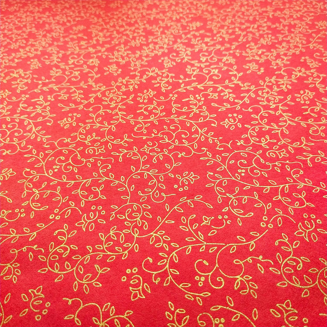 Handmade mulberry paper by Kozo Studio in vibrant red, screen-printed with elegant gold vine and floral patterns for luxurious art and decor.