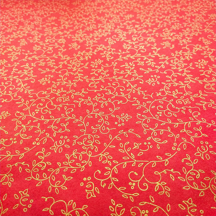 Handmade mulberry paper by Kozo Studio in vibrant red, screen-printed with elegant gold vine and floral patterns for luxurious art and decor.