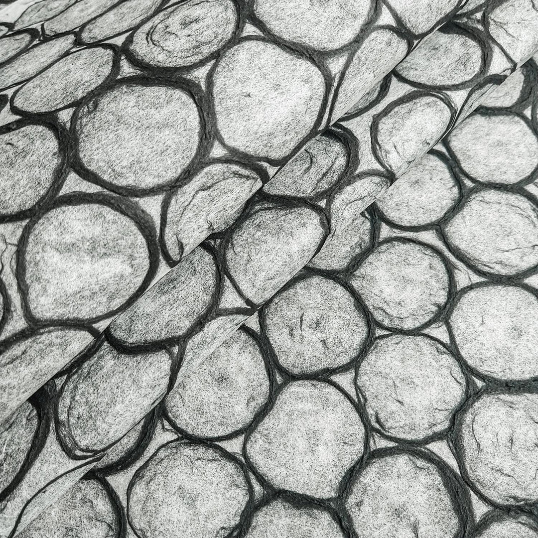 Close-up of Handmade Beehive Kozo Paper by Kozo Studio, showcasing overlapping circular patterns with black outlines on translucent mulberry paper, perfect for lampshades and craft projects.